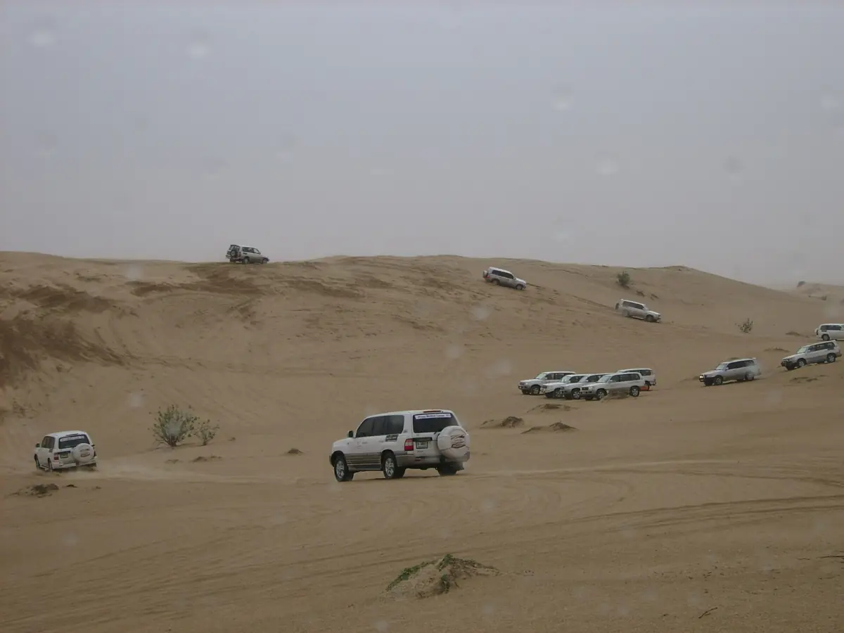 A convoy of 4x4s crossing the desert near Dubai