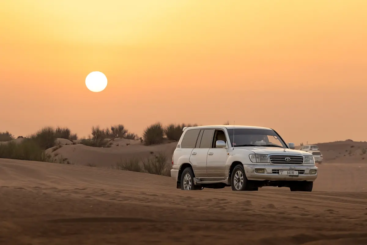 A 4x4 on the dunes outside Dubai at sunset