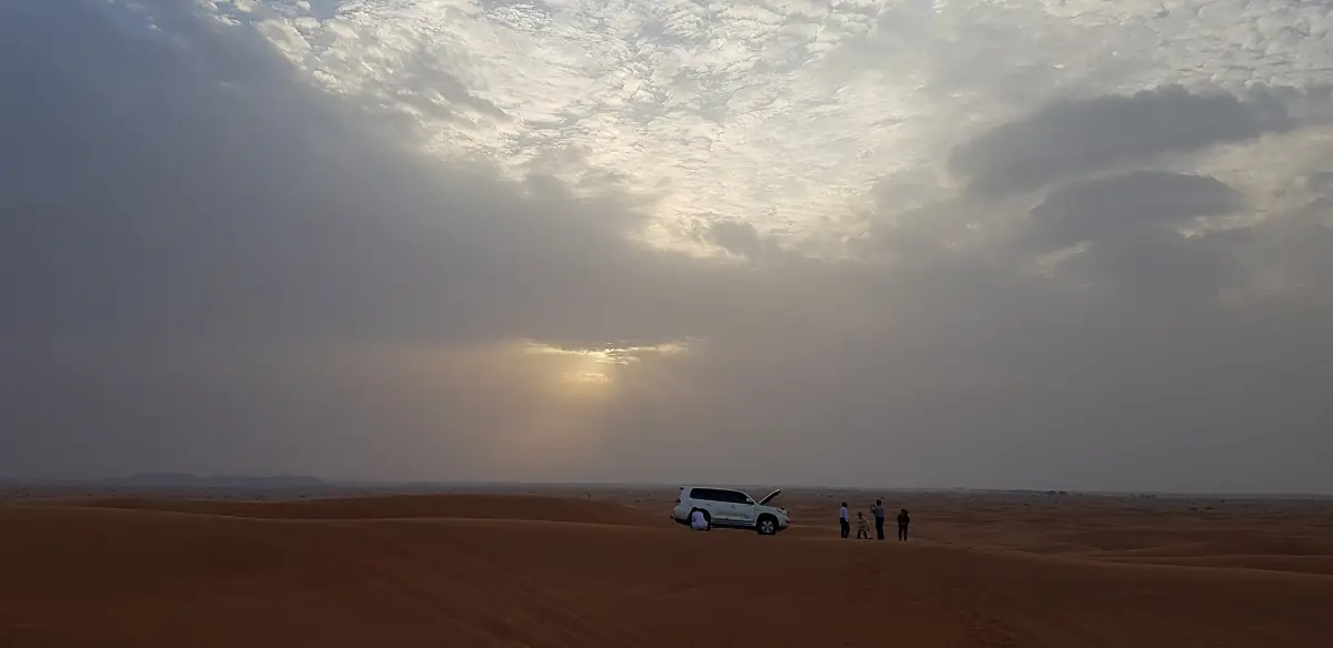The desert near Dubai under a cloudy evening sky