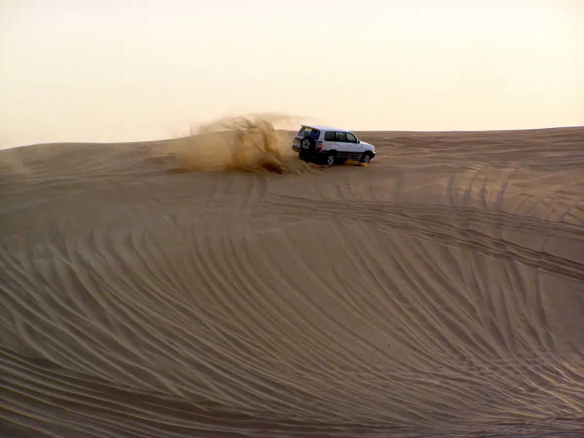 A vehicle dune bashing in the desert near Dubai