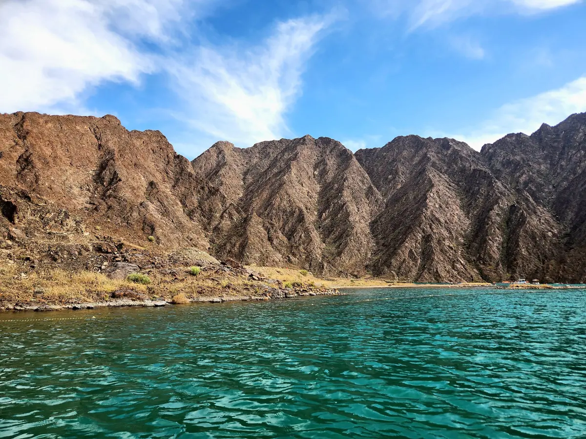 Clear water below rocky cliffs at Hatta