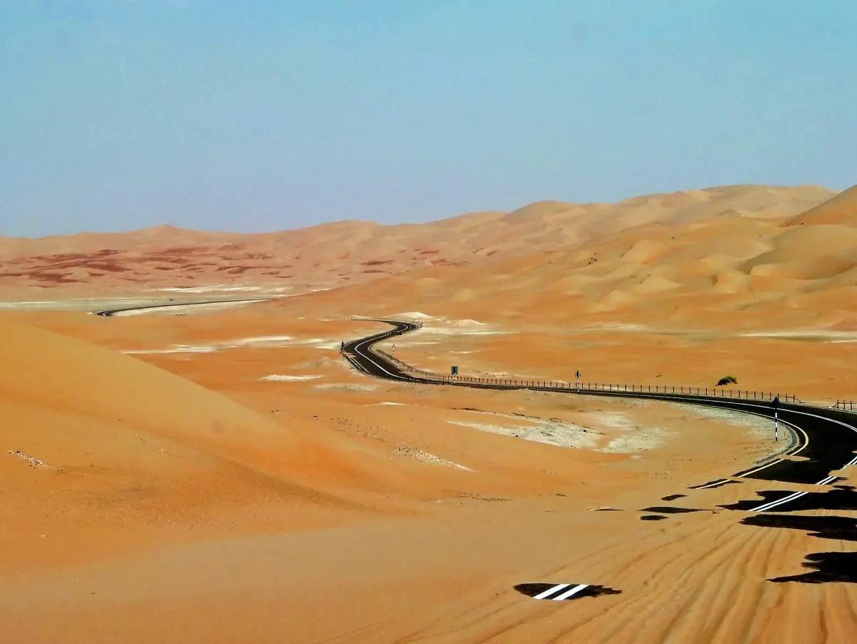 A road winding through the dunes of the Liwa desert