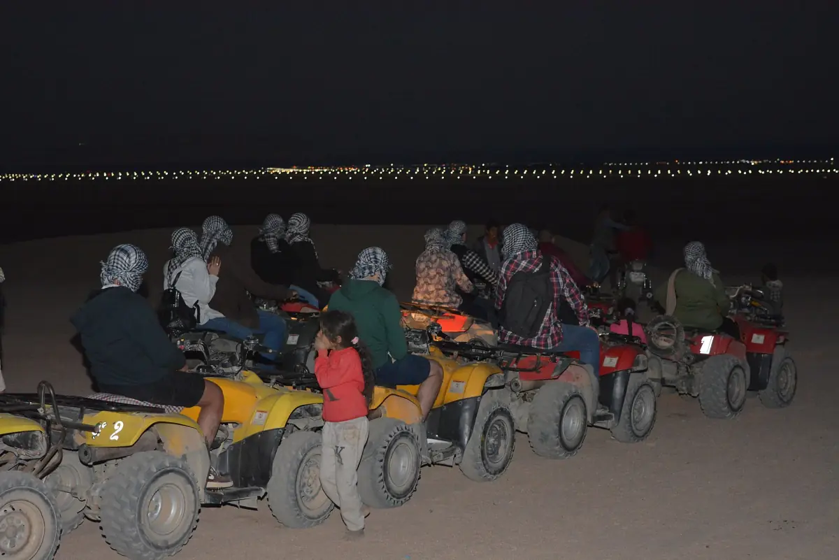 A group of quad bikers on a desert safari